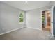 Cozy bedroom features neutral walls, carpet flooring, and a window with backyard views at 9957 Cask Way, Huntersville, NC 28078