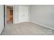 Comfortable bedroom featuring neutral walls and plush carpeting, complemented by a double door closet at 9957 Cask Way, Huntersville, NC 28078