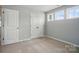 Bedroom with three windows and closet doors at 9957 Cask Way, Huntersville, NC 28078