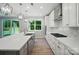 Bright, modern kitchen with stainless steel appliances, white cabinetry and an island sink at 9957 Cask Way, Huntersville, NC 28078