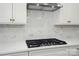 Close up of gourmet kitchen with quartz countertops and stainless steel gas cooktop at 9957 Cask Way, Huntersville, NC 28078