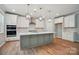 Gourmet kitchen with quartz countertops, island with seating, and stainless steel appliances at 9957 Cask Way, Huntersville, NC 28078