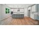 Modern kitchen featuring a gray island, white cabinets, and stainless steel appliances at 9957 Cask Way, Huntersville, NC 28078