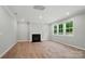 Bright living room with fireplace, recessed lighting and large windows overlooking the backyard at 9957 Cask Way, Huntersville, NC 28078