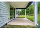 Covered patio with concrete floor overlooks a spacious backyard, perfect for outdoor entertaining and relaxation at 9957 Cask Way, Huntersville, NC 28078