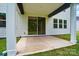 Covered patio with concrete flooring features a sliding glass door and exterior lighting at 9957 Cask Way, Huntersville, NC 28078
