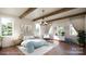 Bright bedroom featuring wood beams, hardwood floors and ample natural light at 10835A Wildlife Rd, Charlotte, NC 28278