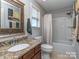Clean bathroom featuring a single sink vanity, decorative mirror, and a tub-shower combination at 12848 Mustang Dr, Midland, NC 28107