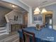 Stylish dining room with modern chandelier and wainscoting detail with an open layout, perfect for entertaining at 12848 Mustang Dr, Midland, NC 28107