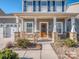 Charming two-story home with a covered front porch and stone pillars at 12848 Mustang Dr, Midland, NC 28107