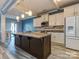Modern kitchen featuring a spacious island, granite countertops, and stainless steel appliances, perfect for cooking at 12848 Mustang Dr, Midland, NC 28107