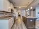 Modern kitchen featuring a spacious island, granite countertops, and stainless steel appliances, with bar stool seating at 12848 Mustang Dr, Midland, NC 28107