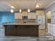 Modern kitchen featuring a spacious island, granite countertops, and stainless steel appliances, perfect for cooking at 12848 Mustang Dr, Midland, NC 28107