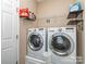 Functional laundry room with modern washer and dryer, and ample storage space at 12848 Mustang Dr, Midland, NC 28107