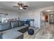 Comfortable living room featuring a gray sectional couch and wood-look flooring at 12848 Mustang Dr, Midland, NC 28107