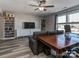 Bright living room with a large window, bookcases, and a dedicated office space at 12848 Mustang Dr, Midland, NC 28107