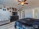 Comfortable bedroom with a large bed, stylish decor, and a view into the bathroom at 12848 Mustang Dr, Midland, NC 28107