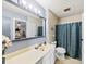 Bathroom features vanity, toilet, shower with a blue curtain, with neutral colors, offering functionality at 1308 Gaston Way, Dallas, NC 28034