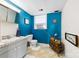 Bright blue bathroom features a modern vanity, toilet, and fixtures, creating a refreshing space at 1308 Gaston Way, Dallas, NC 28034