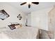 Neutral bedroom featuring ceiling fan, closet and comfortable bed with decorative pillows and floral art at 1308 Gaston Way, Dallas, NC 28034