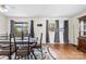 Bright dining room with a modern table set, hardwood floors, and natural light streaming through the windows at 1308 Gaston Way, Dallas, NC 28034
