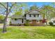 Charming two-story home with a combination of brick and siding, complemented by a well-maintained lawn and mature trees at 1308 Gaston Way, Dallas, NC 28034