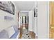 Inviting hallway with a wooden floor, featuring a comfortable bench with decorative pillows and a patterned rug at 1308 Gaston Way, Dallas, NC 28034