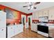 Spacious kitchen with modern appliances, including a stove, white cabinets, and hardwood floors at 1308 Gaston Way, Dallas, NC 28034