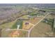 Expansive aerial view of a home's location on a sprawling, partially wooded lot, complete with a tranquil pond at 154 Carters Farm Dr, Statesville, NC 28625