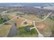 Expansive aerial view of a home's location on a sprawling, partially wooded lot, complete with a tranquil pond at 154 Carters Farm Dr, Statesville, NC 28625