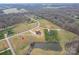 Expansive aerial view of a home's location on a sprawling, partially wooded lot, complete with a tranquil pond at 154 Carters Farm Dr, Statesville, NC 28625
