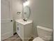 Modern bathroom features a white vanity with round mirror and a toilet with a round tank at 154 Carters Farm Dr, Statesville, NC 28625