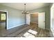 Elegant dining room featuring wood-look floors, neutral walls, a modern light fixture, and natural light at 154 Carters Farm Dr, Statesville, NC 28625