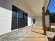 Inviting front porch featuring wood posts and stone accents, providing a welcoming and stylish outdoor space at 154 Carters Farm Dr, Statesville, NC 28625