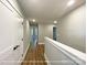Hallway with white trim, hardwood floors, and doors, creating a clean and bright passage at 154 Carters Farm Dr, Statesville, NC 28625