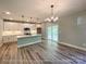 Well-lit kitchen featuring a central island with a sink, modern appliances, and access to an outdoor deck at 154 Carters Farm Dr, Statesville, NC 28625
