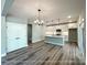 Kitchen showcasing a central island with pendant lighting, white cabinets, and stainless steel appliances at 154 Carters Farm Dr, Statesville, NC 28625
