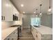 Bright, modern kitchen with white cabinets, stainless steel appliances, and a kitchen island with seating at 154 Carters Farm Dr, Statesville, NC 28625