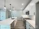 Contemporary kitchen with stainless steel appliances, white cabinets, a quartz countertop, and pendant lighting at 154 Carters Farm Dr, Statesville, NC 28625