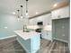 Modern kitchen with stainless steel appliances, white cabinets, and a kitchen island with pendant lighting at 154 Carters Farm Dr, Statesville, NC 28625