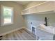 Bright laundry room with a utility sink, shelving, and a window for natural light at 154 Carters Farm Dr, Statesville, NC 28625