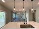 Open-concept layout with a kitchen island featuring a sink, and a view into the living room at 154 Carters Farm Dr, Statesville, NC 28625