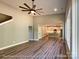 Open-concept living room with wood floors and a view into the kitchen featuring an island and modern appliances at 154 Carters Farm Dr, Statesville, NC 28625