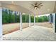 Covered patio with ceiling fan and views of a wooded backyard and surrounding land at 154 Carters Farm Dr, Statesville, NC 28625