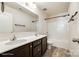 Bathroom featuring double sinks, dark cabinets, and a bathtub-shower combo for convenience at 1929 Shorthorn St, Charlotte, NC 28213
