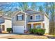 Charming two-story home with attached garage and manicured front landscaping at 1929 Shorthorn St, Charlotte, NC 28213