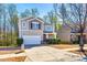 Two-story home featuring an attached garage, inviting front porch, and well-maintained landscaping at 1929 Shorthorn St, Charlotte, NC 28213