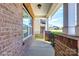 Inviting front porch featuring brick accents and a clear view of the surrounding neighborhood at 1929 Shorthorn St, Charlotte, NC 28213