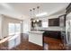 Bright kitchen adjacent to dining area, complete with island, dark cabinets, and modern appliances at 1929 Shorthorn St, Charlotte, NC 28213
