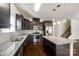 Well-equipped kitchen featuring a granite-topped island, stainless steel appliances, and dark cabinetry at 1929 Shorthorn St, Charlotte, NC 28213